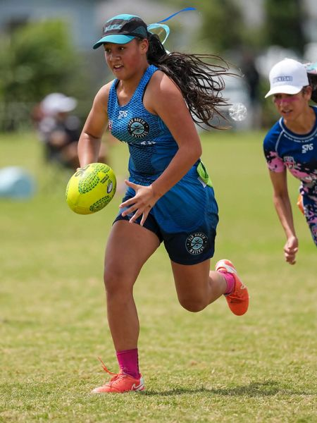 Tag football players contesting the ball